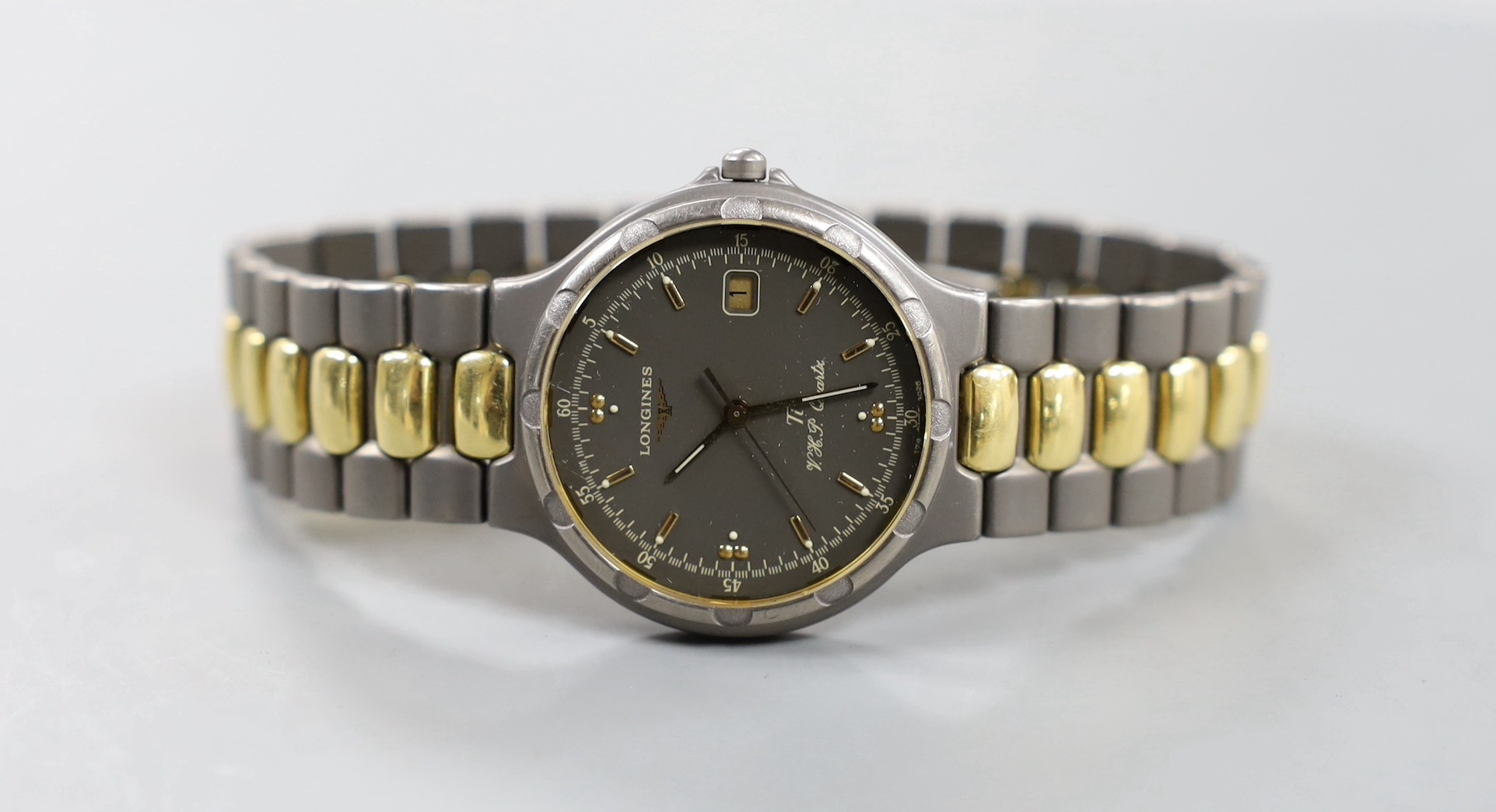 A gentleman's modern steel? and gold plated Longines TI VHP Quartz wristwatch, with box and some papers.